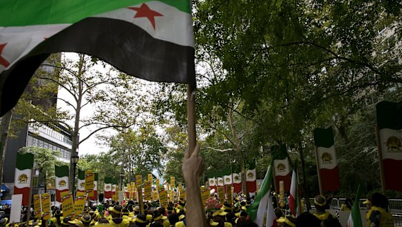 Iranian expats in the US protest against Iranian President Hassan Rouhani outside the UN General Assembly in New York with signs that read "free Iran".