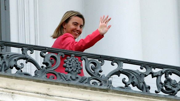 European Union High Representative Federica Mogherini waves on Monday from a balcony of the Palais Coburg where closed-door nuclear talks with Iran continue.