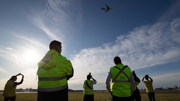 Qantas staff watch as the last Qantas 747 departs Sydney.