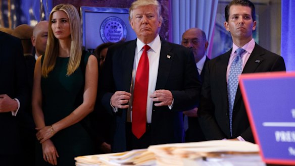 President-elect Donald Trump, accompanied by family members, waits to be introduced for the news conference.