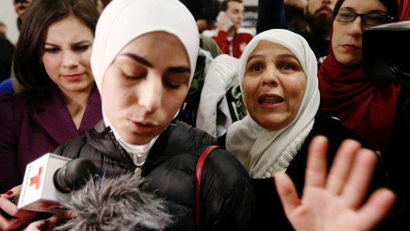 Mariam Yasin, left, translates for her mother Najah al-Shamieh, 55, from Syria, after immigration authorities released her.