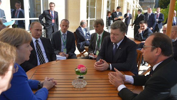 Sitting round a table for talks are from left, clockwise: German Chancellor Angela Merkel, Russian President Vladimir Putin, Ukrainian President Petro Poroshenko and French President Francois Hollande, in Paris on Friday.