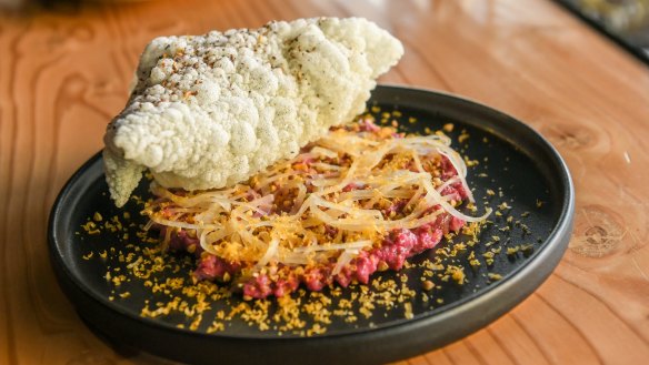 Venison tartare with beetroot cream, kohlrabi, egg yolk and rice cracker.