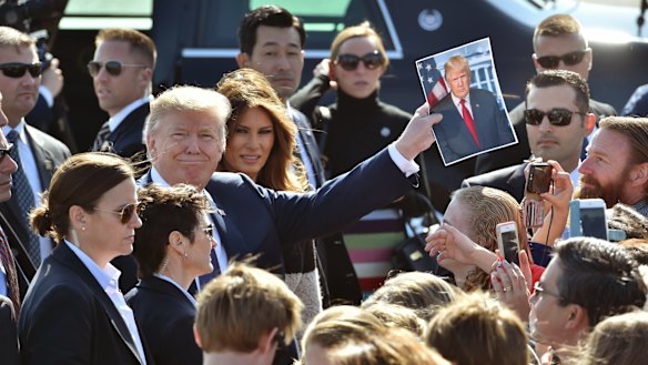 The Trumps greet people after arriving in Japan. 