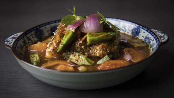 Assam nonya curry with toothfish, a sweet-and-sour dish studded with okra, tomato and red onion.