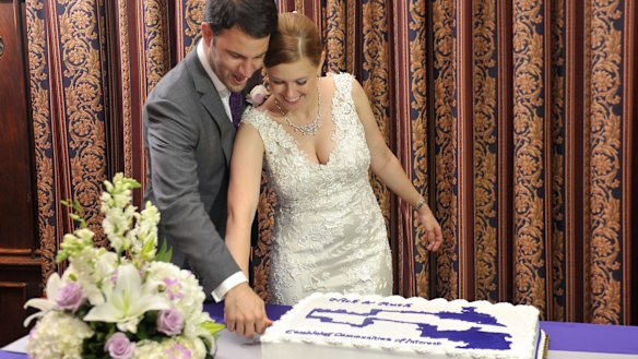 Australian Ruth Greenwood and her husband Nick cut their wedding cake in the shape of the electoral map of Winsconsin.