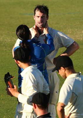 Doolan is assessed by medical staff after being struck by the ball during day two of the Sheffield Shield match between Western Australia and Tasmania at the WACA.