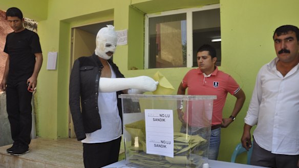 Wounded in Saturday's attack against the pro-Kurdish Peoples' Democratic Party (HDP) rally in Diyarbakir, a Turk casts his ballot on Sunday.