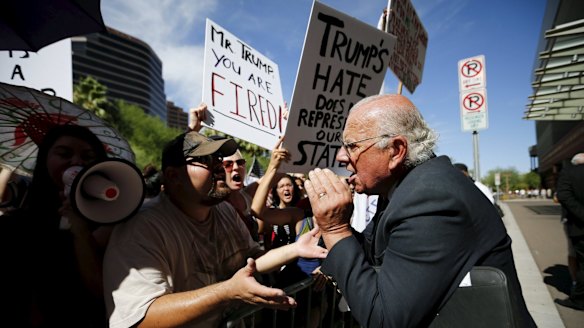 John Coulthard (right), a supporter of Donald Trump, argues with demonstrators outside a Trump campaign event in Phoenix, Arizona, last week.