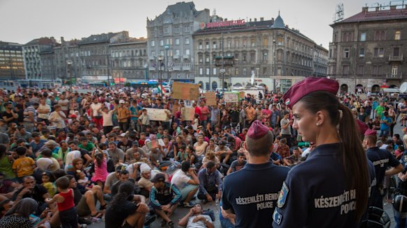 Hungarian police guard the main entrance as migrants protest outside Keleti station in Budapest.