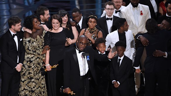 Barry Jenkins, foreground centre, and the Moonlight cast accept the award for best picture.