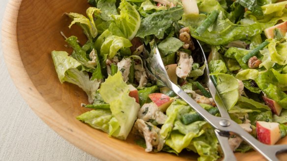 Green salad with chicken, apple and maple walnuts in buttermilk dressing.