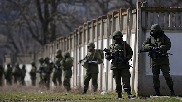 Russian military personnel surround a Ukrainian military base on March 19, 2014.