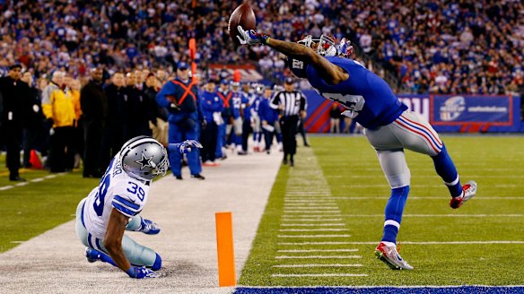 What a catch: New York Giants wide receiver Odell Beckham scores a touchdown against Brandon Carr of the Dallas Cowboys at MetLife Stadium on November 23, 2014.