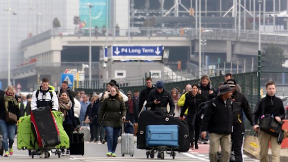 Passengers are evacuated from Brussels airport after the blast on Tuesday morning. 