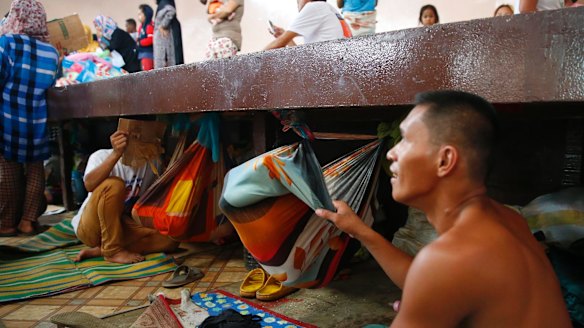 A displaced resident of Marawi city puts his baby to sleep at an evacuation centre in Balo-i, southern Philippines.