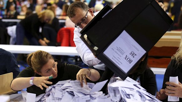 Ballot boxes are emptied to be counted in Glasgow, Scotland, on Thursday.