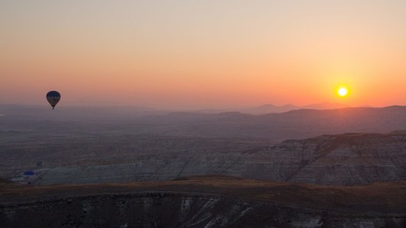 Watching the sunrise from a hot air balloon in  Cappadocia.
