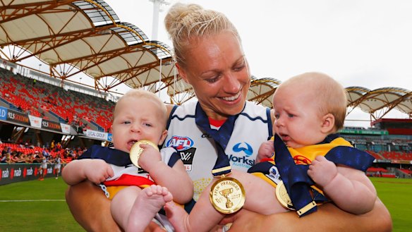 Hands full: Erin Phillips celebrates with twins Blake and Brooklyn after Adelaide's win in the AFLW grand final.