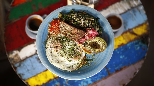 The breakfast plate at Ora includes ghee-fried eggs and gluten-free seed and nut bread.