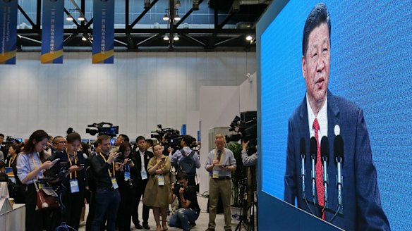 Journalists at the Belt and Road Forum's press centre watch Chinese President Xi Jinping giving the keynote speech.