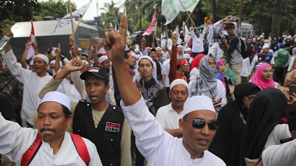 Indonesian Muslims  demonstrate outside the court where Jakarta Governor Basuki Tjahaja Purnama, also known as Ahok, is facing blasphemy charges.