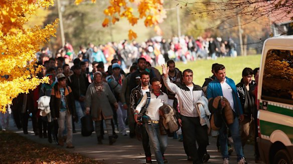 German police lead  refugees from Wegscheid, near the Austrian border to a transport facility on Wednesday.