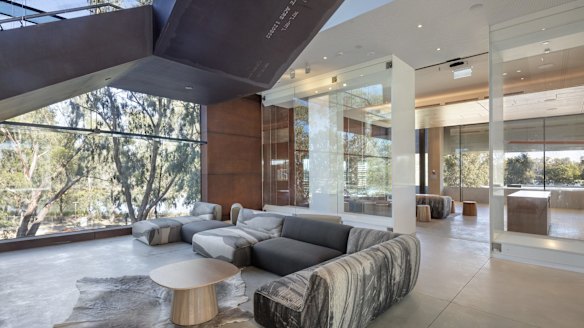 The building was conceived as "land art" and the imposing grey exterior soon reveals red ochre side panels, a series of functional spaces and an arresting view beyond.