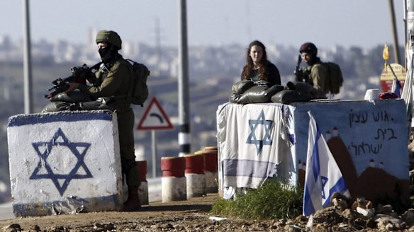 Israeli soldiers stand guard outside settlements in the occupied West Bank in March. The Republican platform rejects the notion that the territory is occupied.