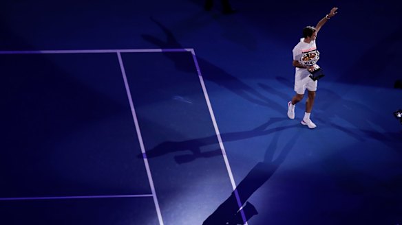 Roger Federer does a lap of honour with a grand slam trophy for the 20th time.