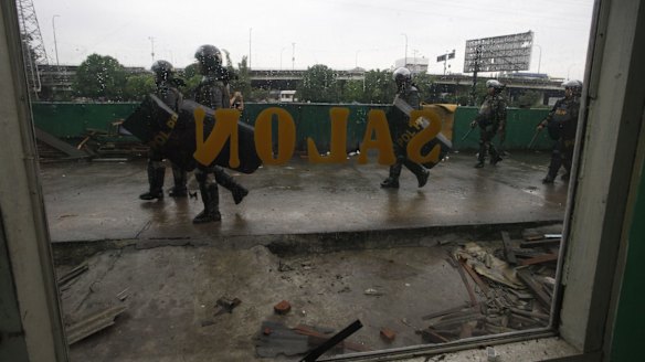 Security goverment troops prepare to oversee the demolition of buildings in Kalijodo.