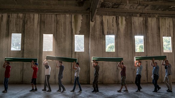 Coffins of the victims of the Srebrenica massacre are taken from a former battery factory in Potocari to be buried at a nearby cemetery and memorial centre, in Bosnia in 2016.