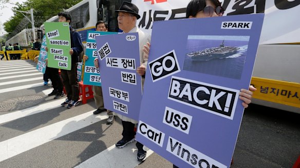 South Koreans stage a rally against deployment of the aircraft carrier USS Carl Vinson.
