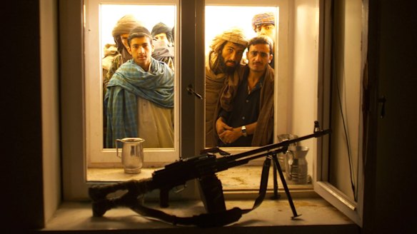 Afghans look through the window into the bedroom of Taliban spiritual leader Mullah Omar in his compound on the outskirts of the Afghan city of Kandahar in 2001.