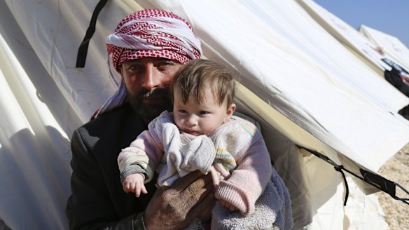 Displaced Syrians at a temporary refugee camp in northern Syria near the Bab al-Salameh border crossing with Turkey.
