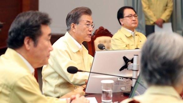 South Korean President Moon Jae-in, centre, presides over a cabinet meeting in Seoul as his country's and American troops begin annual military drills.