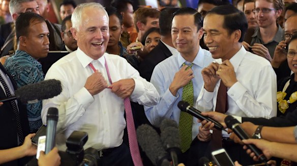 Relaxed: Prime Minister Malcolm Turnbull and Indonesian President Joko Widodo take off their ties during a visit to Tanah Abang Market in Jakarta in November 2015. 