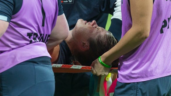 An injured Brianna Davey of the Blues is carried from the field.
