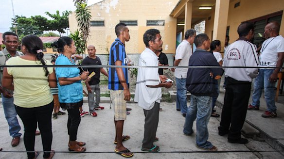 People queue to vote voluntarily in East Timor presidential elections in Farol, Dili, on Monday.