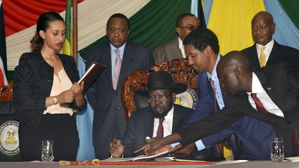 South Sudan President Salva Kiir, seated, signs a peace deal on Wednesday, watched by Kenya's President Uhuru Kenyatta, centre-left, Ethiopia's Prime Minister Hailemariam Desalegn, centre-right, and Uganda's President Yoweri Museveni, right. 