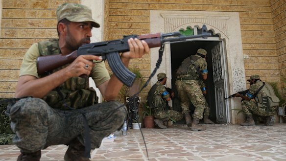 Members of the Free Syrian Army carry out a house-to-house search of Jarablus after taking control of the town from Islamic State as part of "Operation Euphrates Shield".
