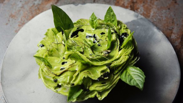 A rosette of iceberg lettuce, coconut, lime and charcoal.