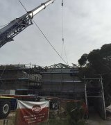 Cranes help place the finishing touches on the roof of the Guildford hotel