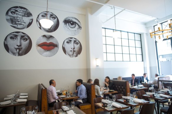 Fornasetti wallpaper makes a striking feature at Massi in Melbourne.