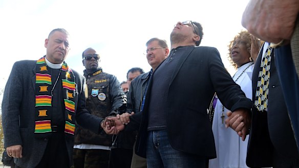 A group of pastors from area churches hold a prayer vigil in San Bernardino on Thursday.