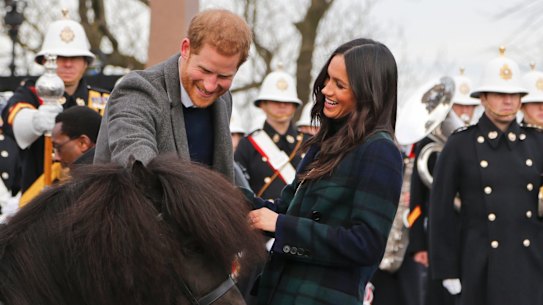 Prince Harry and Meghan Markle meet a Shetland Pony at Edinburgh Castle in Scotland.