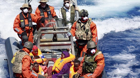 Pregnant Somali refugee, Rahma Abukar Ali (centre), in a German Navy boat in the Mediterranean Sea, near Italy.  