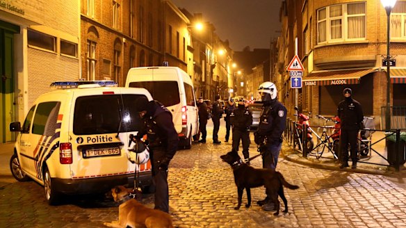 Police officers guard a road after raids in which several people, including Paris attacks suspect Salah Abdeslam, were arrested in Sint-Jans-Molenbeek last week.