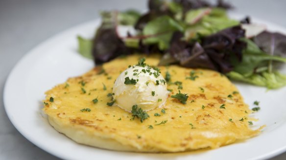 Cheese and potato pancake topped with whipped butter.