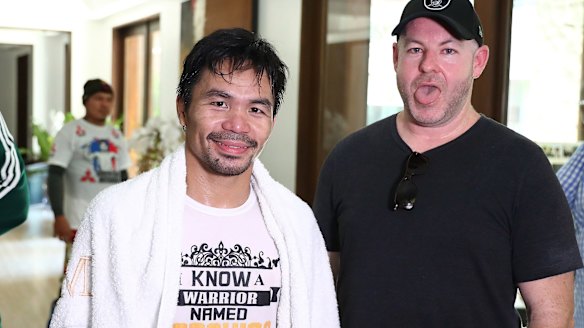 Working up a sweat: Manny Pacquiao with Andrew Webster after a training run on the streets of Manila.